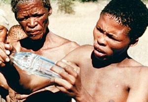 bushmen admiring the empty bottle