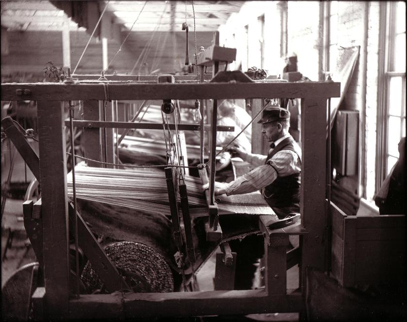 Employee weaving at the Carlisle Carpet Mill